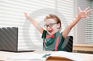 Online remote learning. Excited school kids with computer having video conference chat with teacher in class. Child