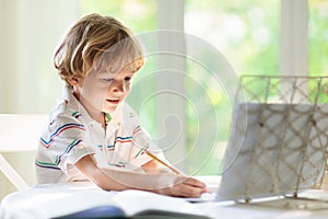 Online remote learning. School kid doing homework