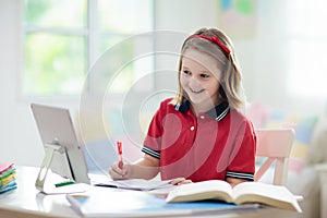 Online remote learning. School kids with computer