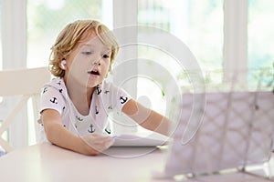 Online remote learning. School kids with computer