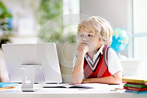 Online remote learning. School kids with computer