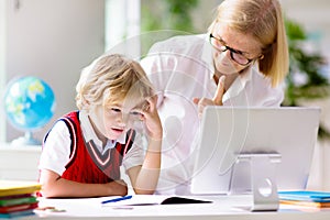 Online remote learning. School kids with computer