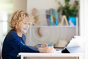 Online remote learning. School kids with computer