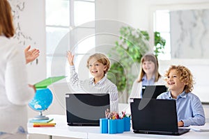 Online remote learning. School kids with computer