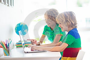 Online remote learning. School kids with computer