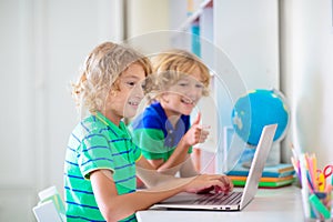 Online remote learning. School kids with computer