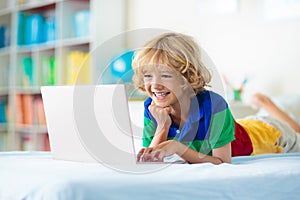 Online remote learning. School kids with computer