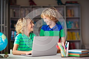 Online remote learning. School kids with computer