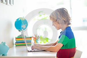 Online remote learning. School kids with computer