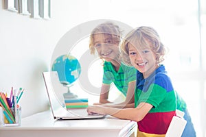 Online remote learning. School kids with computer