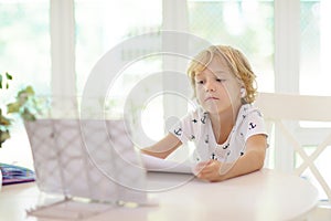 Online remote learning. School kids with computer