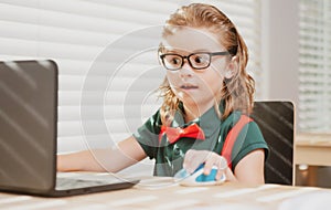 Online remote learning. School kids with computer having video conference chat with teacher in class. Child studying at