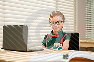 Online remote learning. School kids with computer having video conference chat with teacher in class. Child studying at