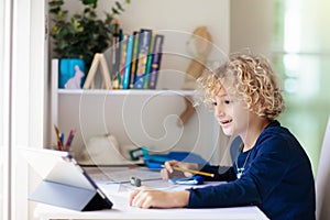 Online remote learning. School kids with computer