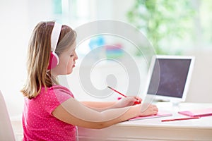 Online remote learning. School kids with computer