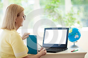 Online remote learning. Teacher with computer