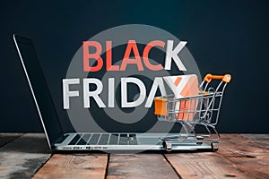 Online sale and Black Friday concept, laptop and shopping cart