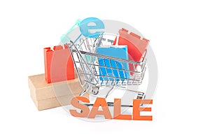 Online Sale Shopping Concept: Shopping Cart with Paper Bags and \'Sale\' Sign on White Background