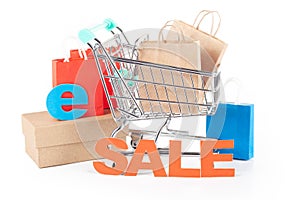 Online Sale Shopping Concept: Shopping Cart with Paper Bags and \'Sale\' Sign on White Background