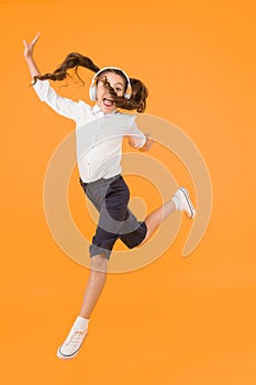 Online schooling. Dancing lesson. Child enjoy music sound. Audio schooling. Home schooling. Small girl pupil headphones