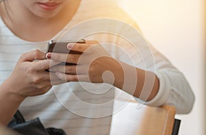 Online searching social networks by Smartphone Concept: Close-up Business woman holding mouse and using modern smartphone laptop
