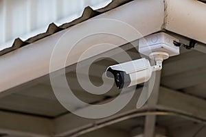 Online Security CCTV camera surveillance system outdoor of house. A blurred night city scape background. Real time Modern CCTV cam