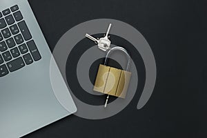 Online security. Internet protection. Password for computer. Laptop and padlock with key on black background