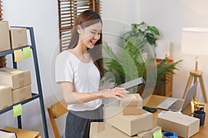 Online selling concept, Asian business women is checking products for prepare delivery to customer