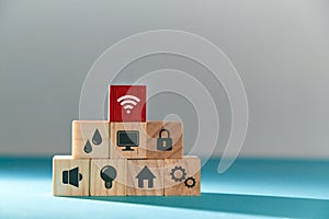 Online services. E-payment of utility services. Pyramid of wooden cubes with public utilities signs, red block on top