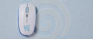 Online shopping, buying and e-commerce. Computer mouse with cymbol of basket. Blue background