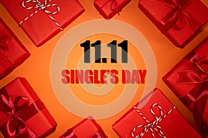 Online shopping of China, 11.11 single`s day sale concept. Top view of christmas boxes with red ribbon on red and orange