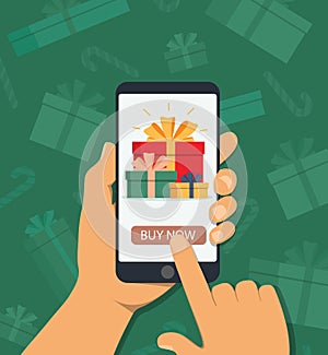 Online shopping for christmas gifts. Eshop of holiday presents in mobile phone. Hand holds phone with online shopping app for photo