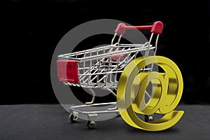 Online shopping concept with cart and 3D email sign