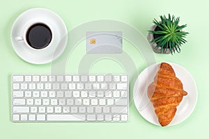 Online shopping concept. Computer keyboard, credit card and coffee with copy space