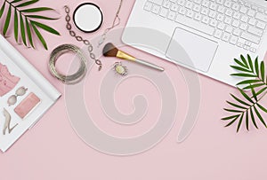 Online shopping concept with computer, pink background, catalog and products