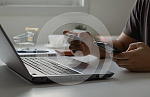 Online shopping concept. Customer makes a purchase on the Internet on a smartphone with a credit card, online payment