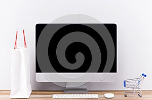 Online shopping concept with desktop computer screen .