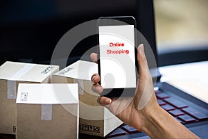 Online shopping concept e-commerce delivery buying service. square cartons shopping on laptop keyboard, showing customer order vi