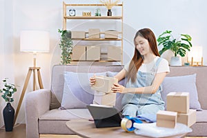 Online shopping concept, Female entrepreneur checking parcel boxes while preparing send to client