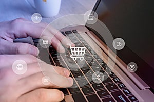 Online shopping concept on laptop. Levitating icons of shopping cart, photo