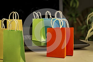 Online shopping concept. little colorful shopping bags stand on laptop.