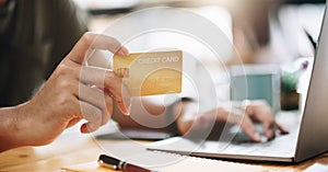 Online shopping concept, A man hands holding using mobile smart phone and credit card making online payment with laptop