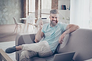 Online shopping concept. Portrait of handsome young man sitting