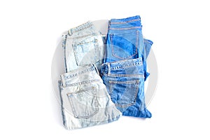 Online shopping concept. set of jeans trousers of different colors on a white background. simple flat lay, top view