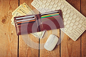 Online shopping concept with wallet, money and keyboard. Retro filter effect