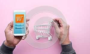 Online shopping concepts with person and small trolley moving to smartphone.Ecommerce market.Transportation logistic.Business photo