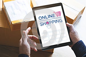 Online shopping concepts with youngman using tablet on product package box.Ecommerce market.Transportation logistic.Business