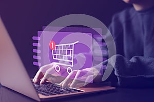 Online shopping and e-commerce technology internet concept. Woman or Shopper using a laptop computer with shopping cart icon,