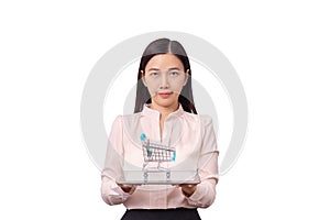 Online shopping and E-commercial business concept. Asian beautiful woman holding tablet in hand with shopping cart on top isolated