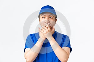 Online shopping, fast shipping, employees and home delivery concept. Close-up of shocked and astounded asian male